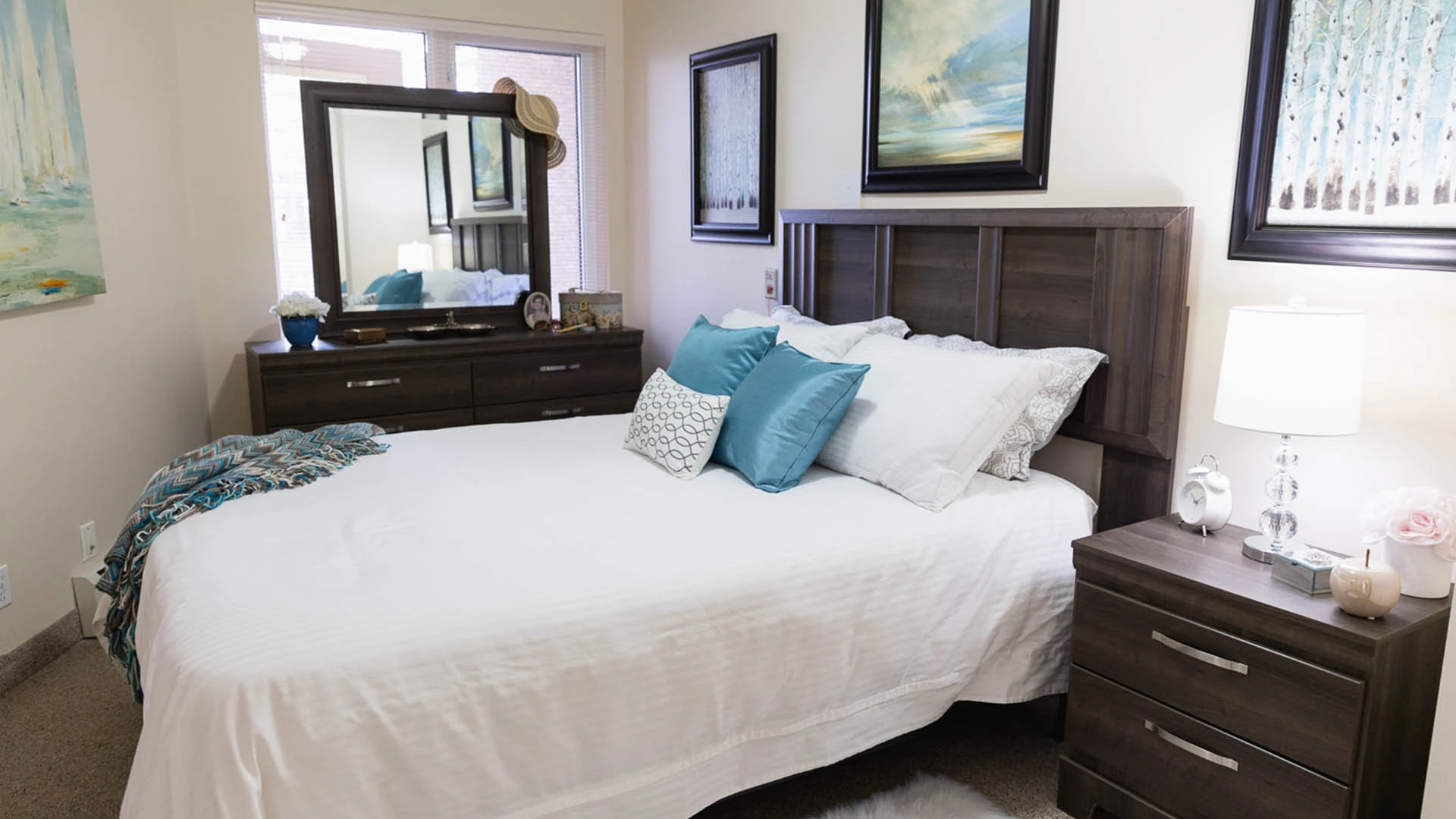 Bedroom with dark brown furniture and white bedding