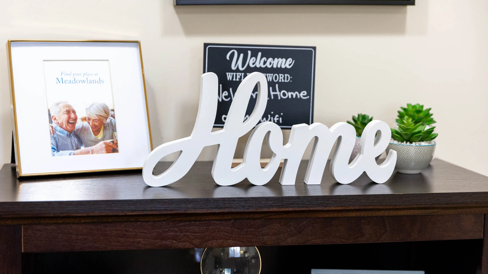 Table with a Home sign and pictures