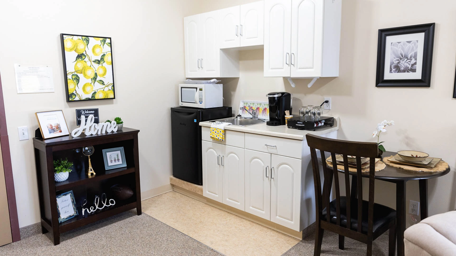 Small kitchen area with sink, fridge and microwave