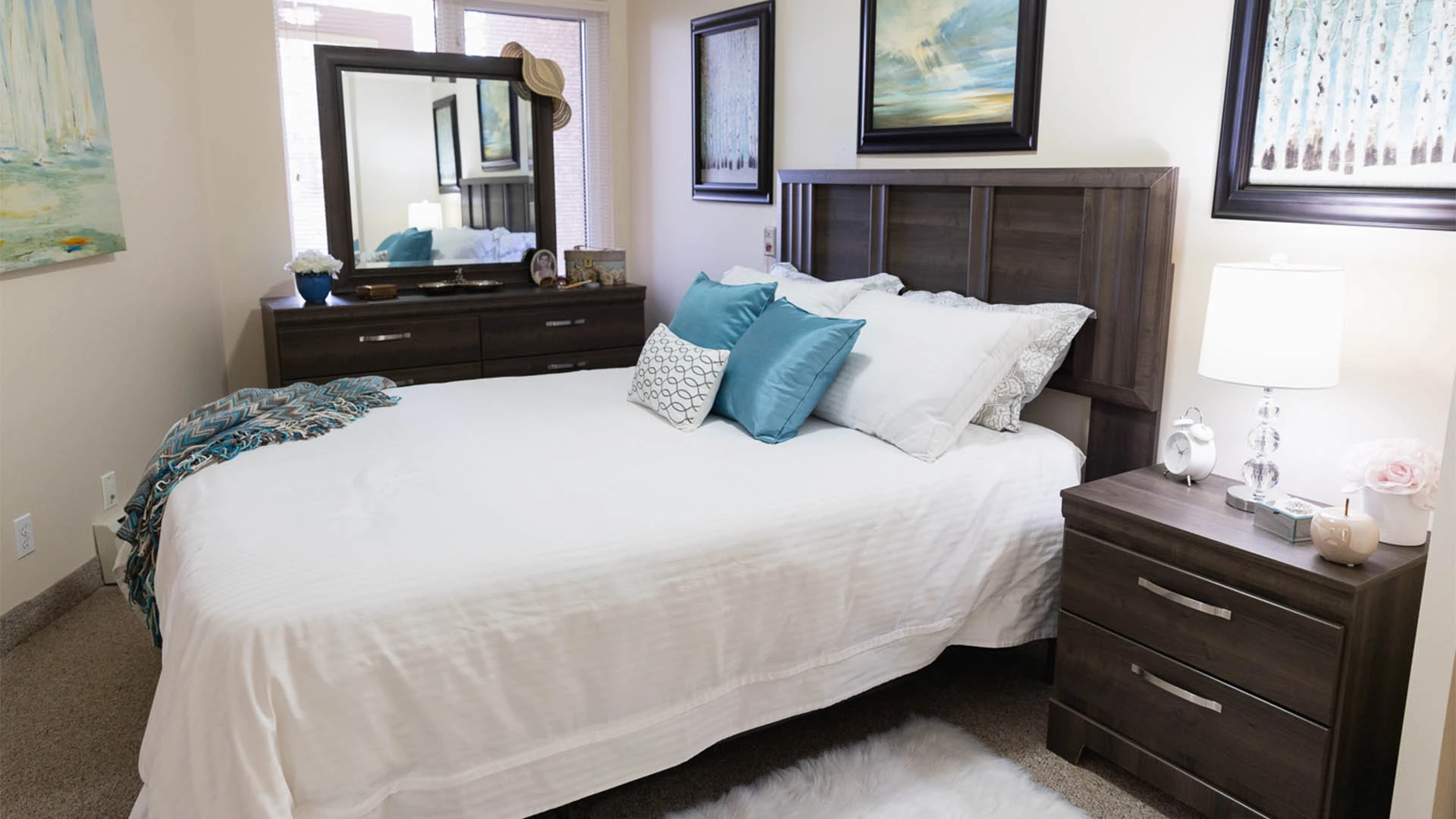 Bedroom with brown furniture and a white bedding