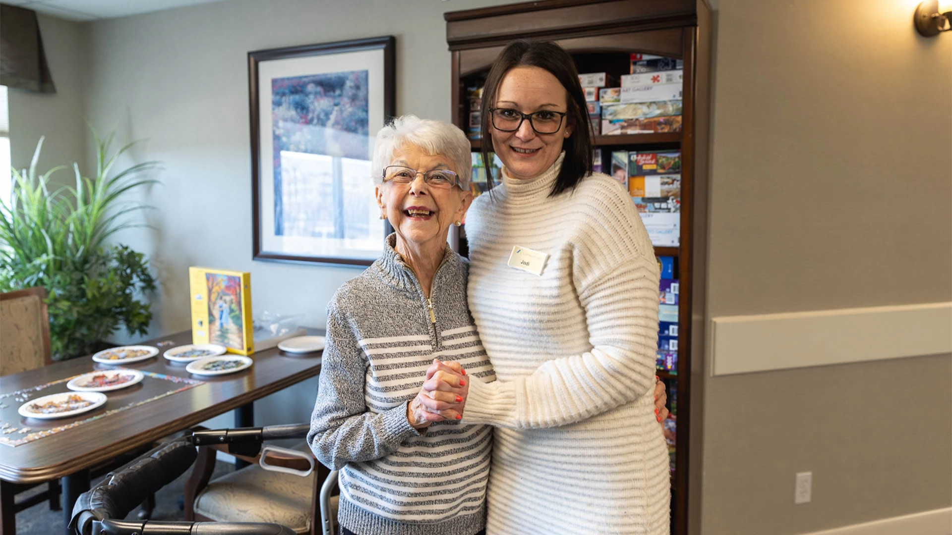 Senior smiling with a staff member