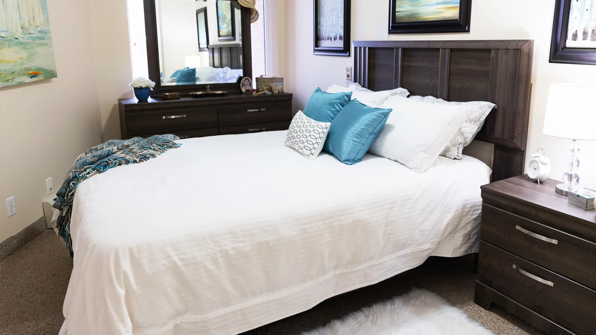Bed in bedroom with blue pillows