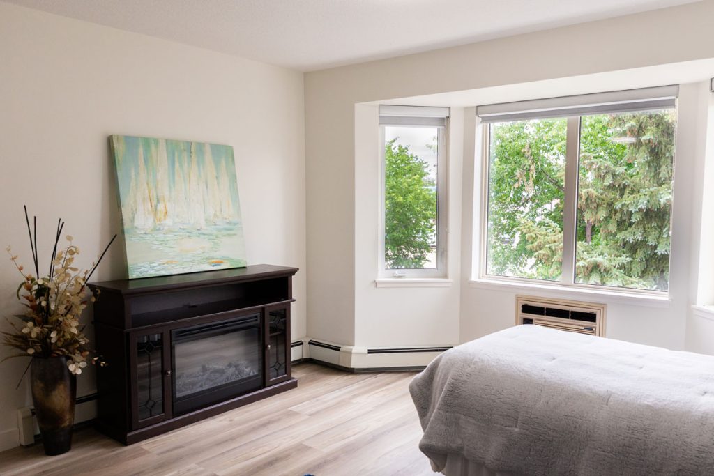 suite living area with fireplace and artwork