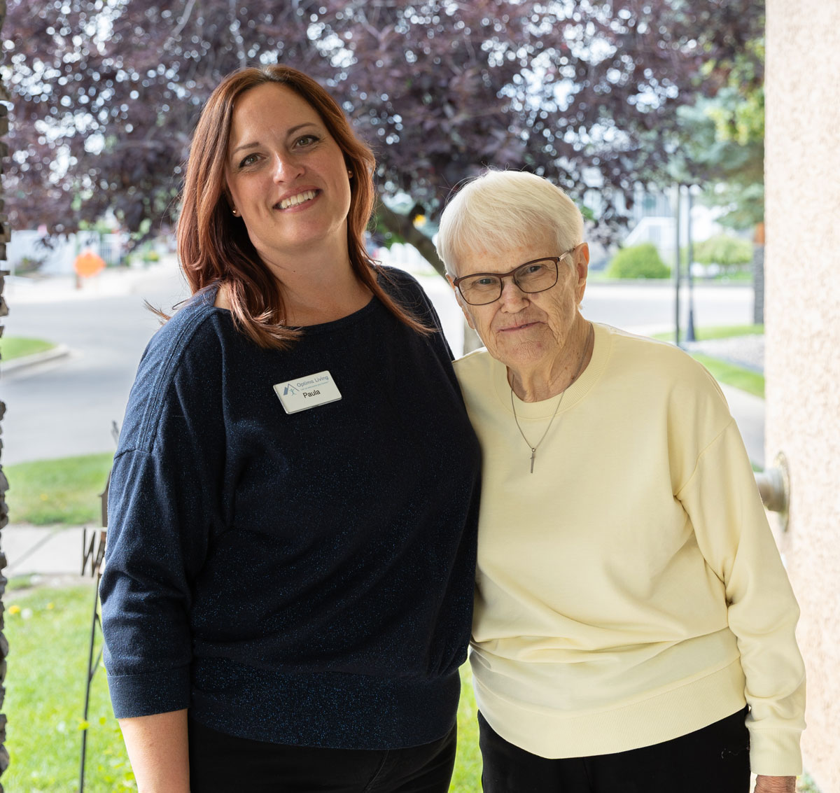 team member and resident standing outside