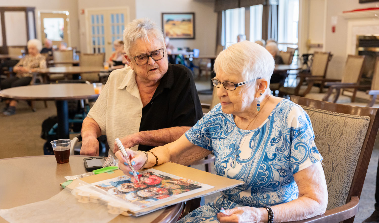 two residents enjoying arts and crafts activity